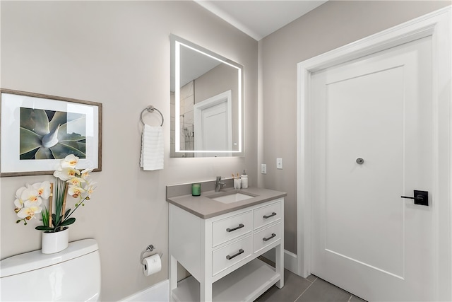 bathroom featuring toilet, tile patterned floors, and vanity