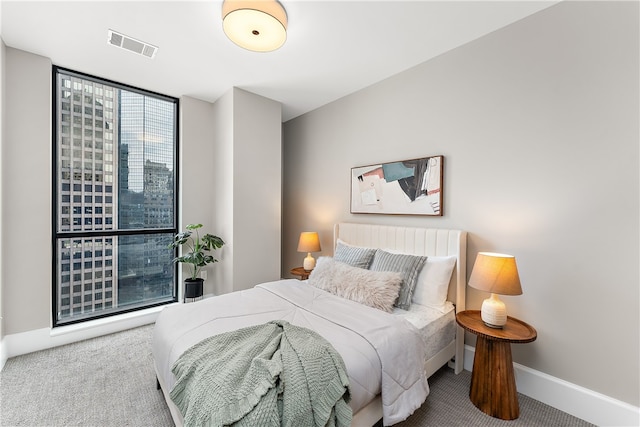 bedroom featuring carpet flooring and expansive windows