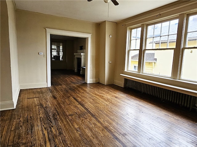 unfurnished room with ceiling fan and dark wood-type flooring