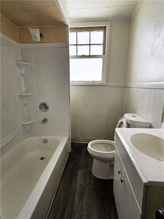 full bathroom featuring toilet, vanity, tub / shower combination, and hardwood / wood-style floors