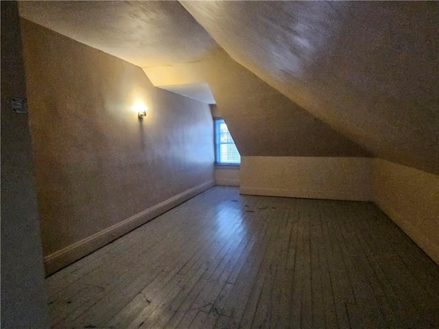 bonus room featuring wood-type flooring and lofted ceiling