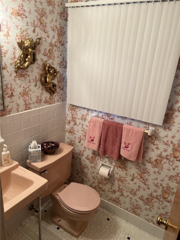 bathroom with sink, toilet, and tile patterned flooring