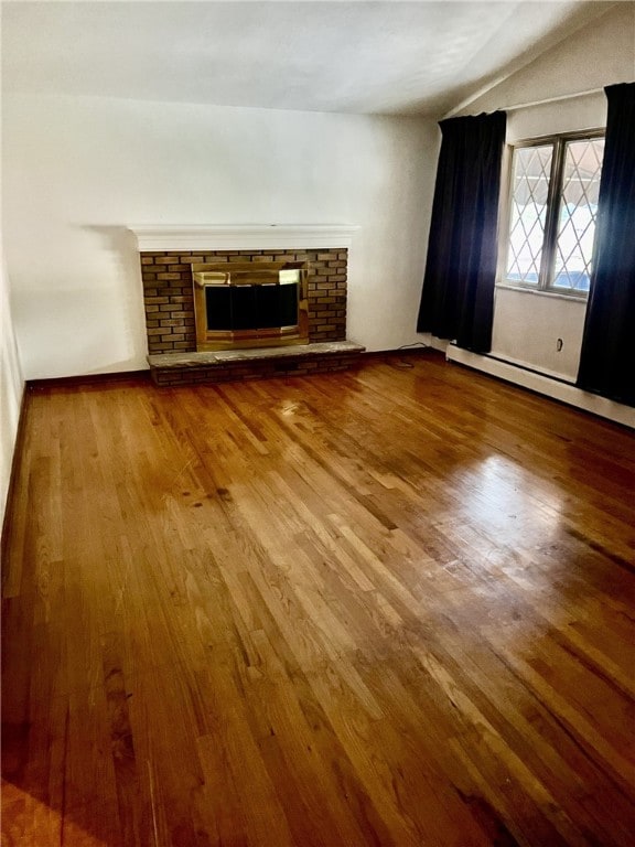 unfurnished living room featuring a fireplace and hardwood / wood-style floors