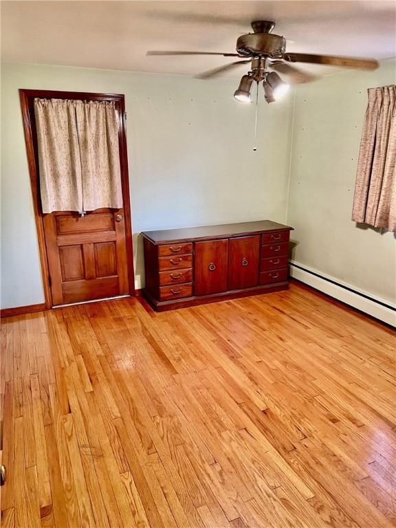 empty room featuring ceiling fan and light hardwood / wood-style floors