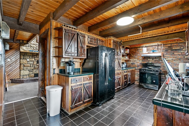 kitchen with dark tile patterned flooring, beamed ceiling, black appliances, extractor fan, and wood ceiling