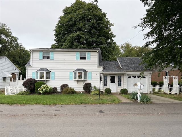 view of front of property with a garage and a front yard