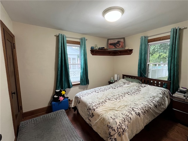 bedroom featuring multiple windows and hardwood / wood-style flooring