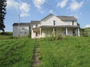 rear view of property with a lawn