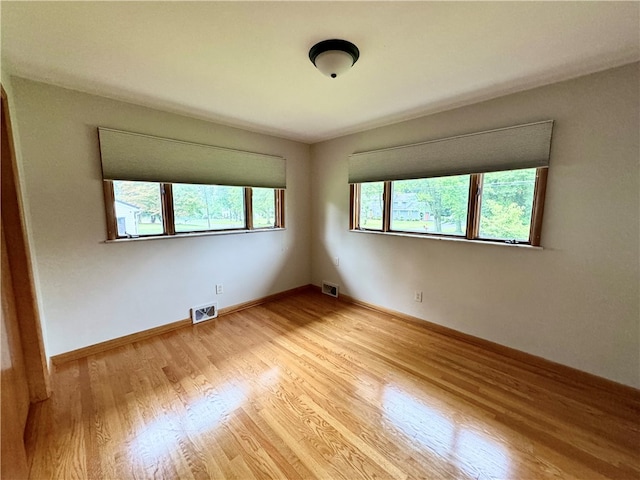 unfurnished room featuring light hardwood / wood-style floors