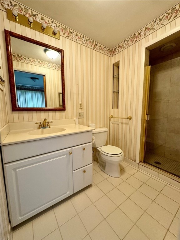 bathroom featuring tile patterned flooring, toilet, and vanity