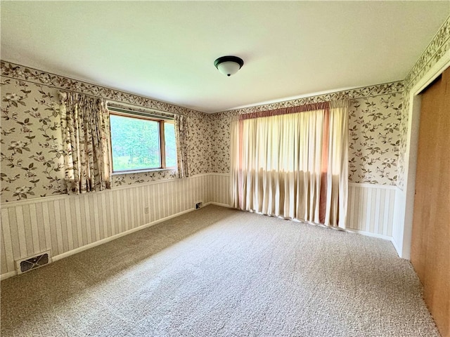 unfurnished room featuring carpet flooring