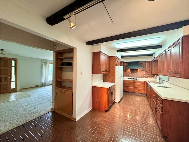 kitchen featuring backsplash, beam ceiling, carpet, wall chimney exhaust hood, and white refrigerator