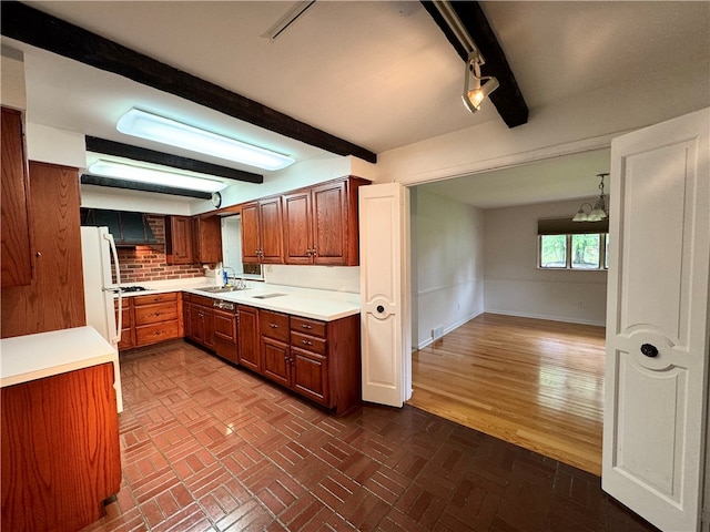 kitchen with beam ceiling, decorative backsplash, sink, hardwood / wood-style flooring, and white refrigerator