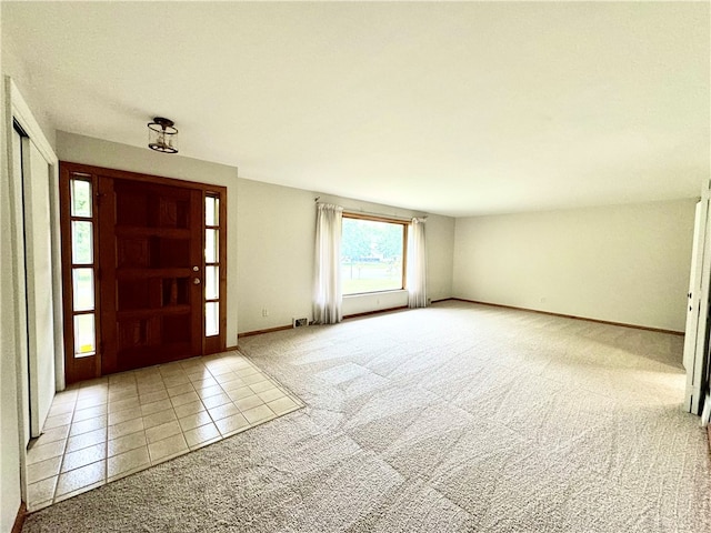 view of carpeted foyer entrance