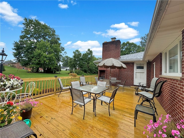 wooden terrace featuring a yard