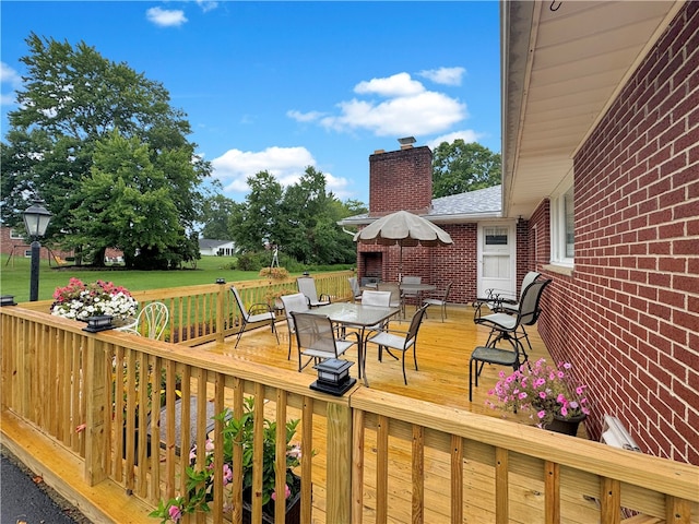 wooden deck featuring a lawn