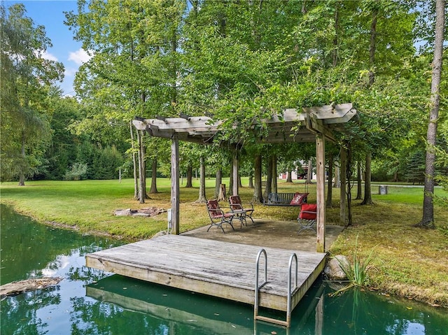 view of dock with a yard and a water view