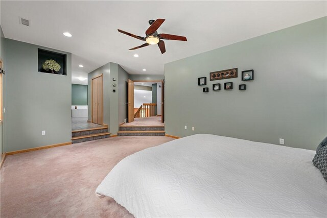 carpeted bedroom featuring ceiling fan and connected bathroom