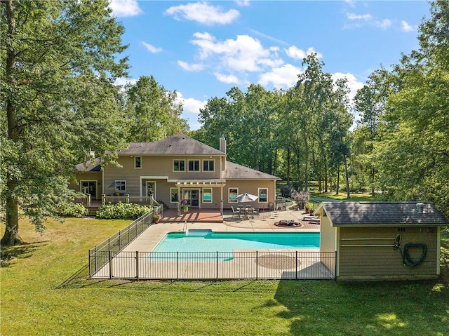 view of swimming pool with a fenced in pool, a lawn, a deck, and fence