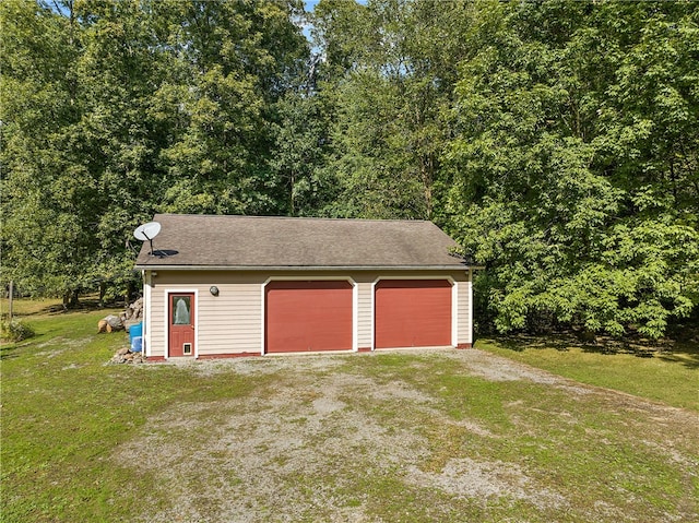 garage featuring a yard