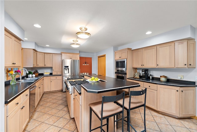 kitchen with sink, stainless steel appliances, light tile patterned flooring, and a center island