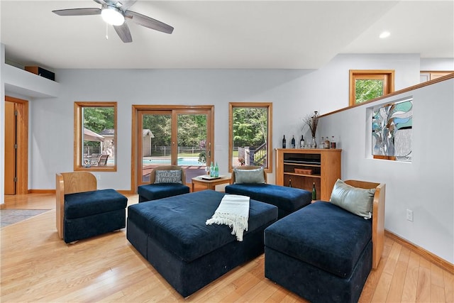 living area featuring hardwood / wood-style flooring, recessed lighting, a ceiling fan, and baseboards