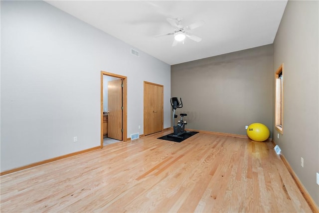 workout room with visible vents, baseboards, wood finished floors, and a ceiling fan