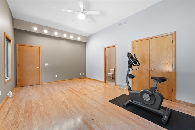 exercise room featuring ceiling fan and light hardwood / wood-style flooring