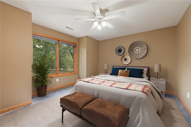 bedroom featuring ceiling fan and light carpet