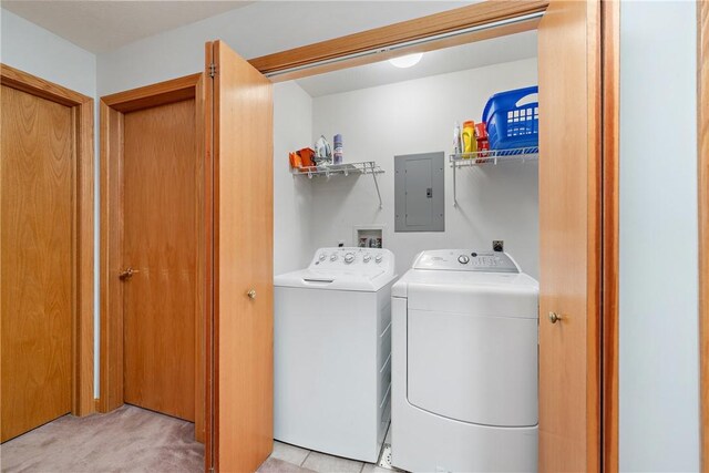 clothes washing area featuring independent washer and dryer, light carpet, and electric panel