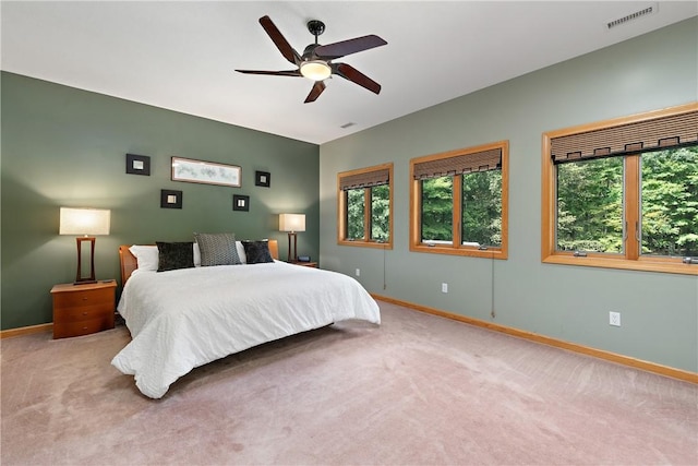 bedroom with visible vents, baseboards, carpet, and ceiling fan