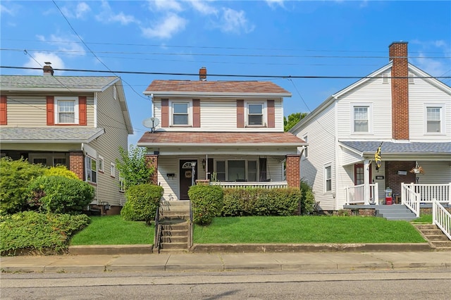 view of front of property with a front yard and covered porch