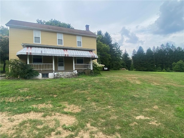 rear view of property with a lawn