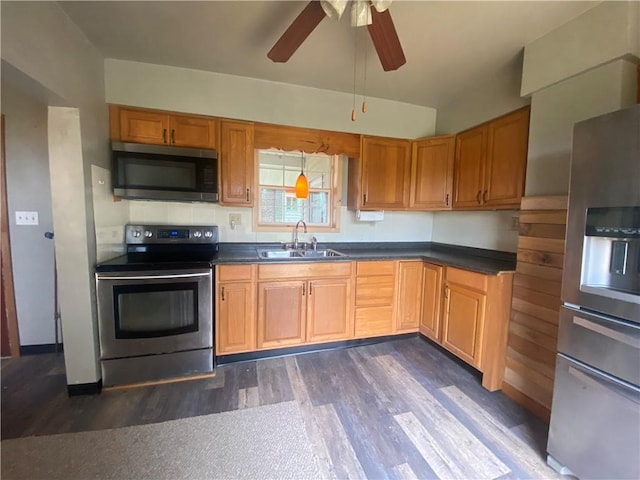 kitchen with sink, dark wood-type flooring, and stainless steel appliances