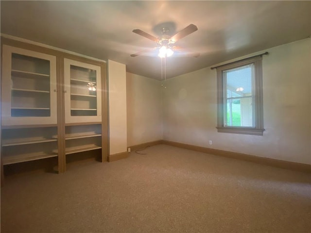 spare room featuring ceiling fan and carpet flooring