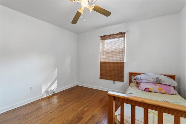 bedroom with ceiling fan and hardwood / wood-style flooring