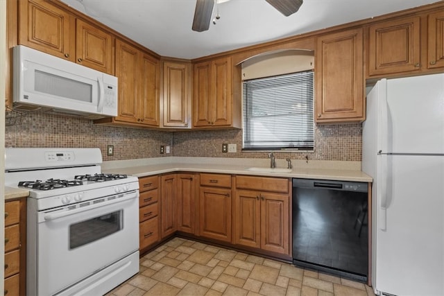 kitchen with tasteful backsplash, sink, light tile patterned floors, white appliances, and ceiling fan