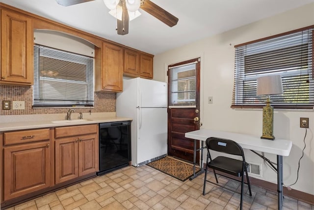 kitchen featuring dishwasher, decorative backsplash, sink, light tile patterned floors, and ceiling fan