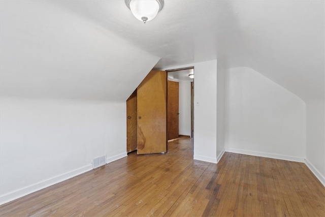 bonus room featuring vaulted ceiling and hardwood / wood-style floors