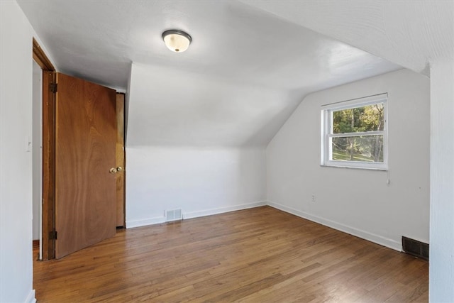 bonus room featuring hardwood / wood-style floors and vaulted ceiling