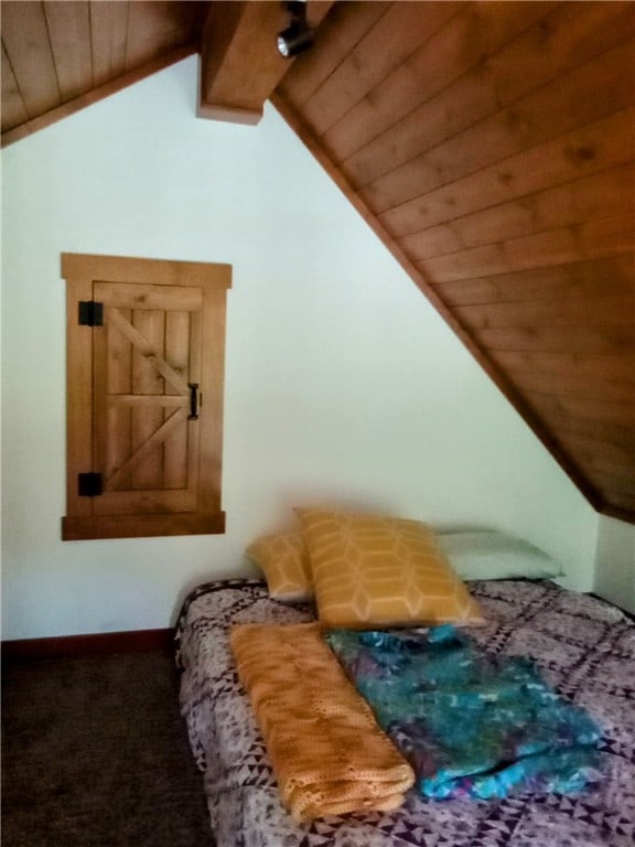 bedroom featuring carpet floors, wooden ceiling, and lofted ceiling with beams