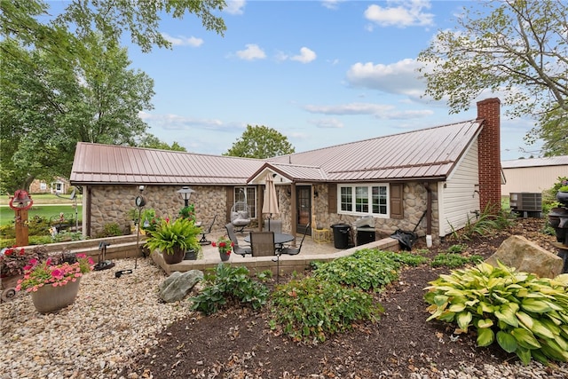 rear view of property featuring a patio area and central air condition unit