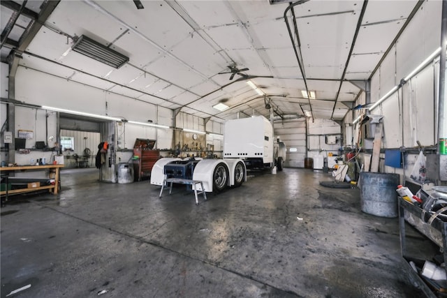 garage featuring ceiling fan and a workshop area