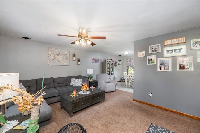 living room featuring light carpet and ceiling fan