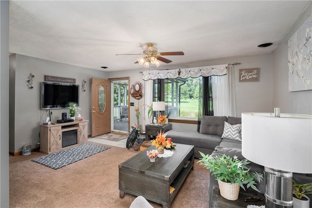 carpeted living room featuring ceiling fan