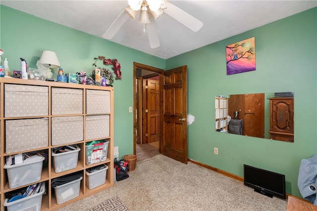 interior space with light colored carpet and ceiling fan