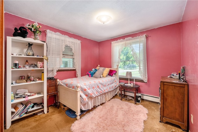 carpeted bedroom featuring multiple windows, a textured ceiling, and baseboard heating