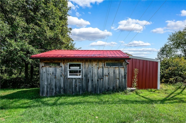 view of outbuilding featuring a yard