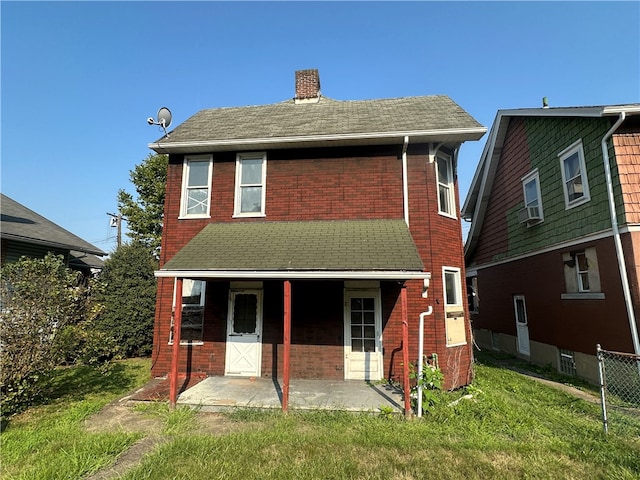 back of property featuring a patio and a yard