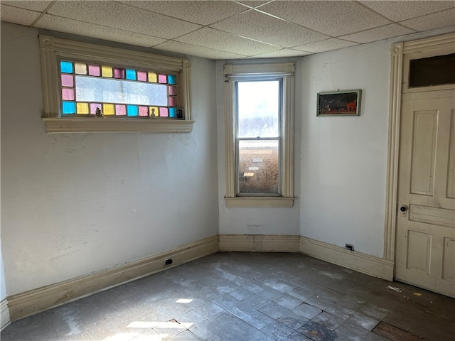 unfurnished room featuring a paneled ceiling